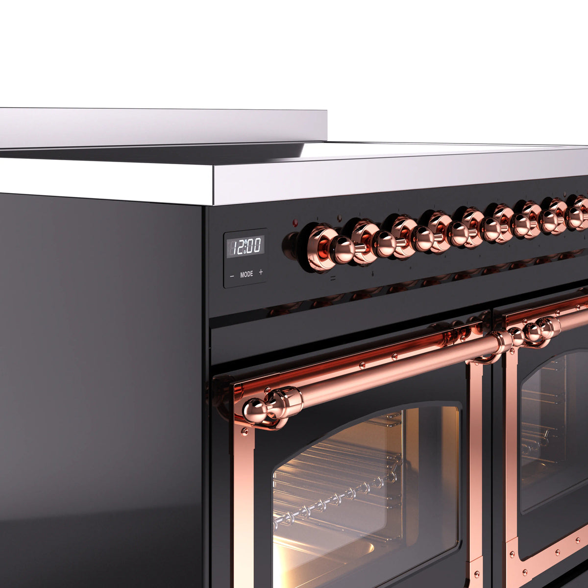Induction range close-up of copper control knobs and copper-trim oven door frames