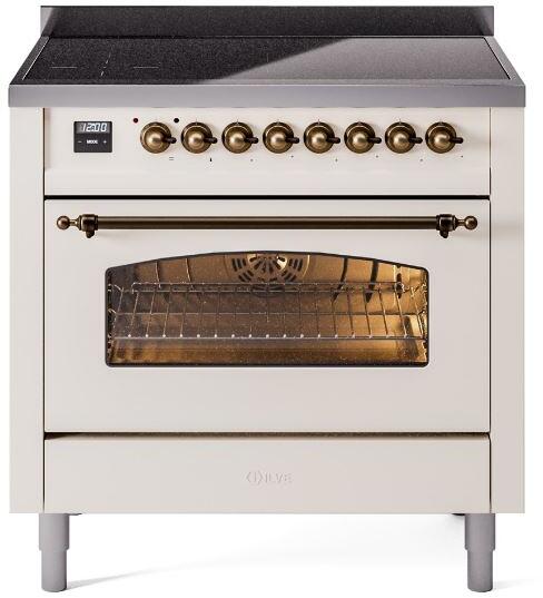 Freestanding electric induction range with bronze knobs and open oven door with lit interior