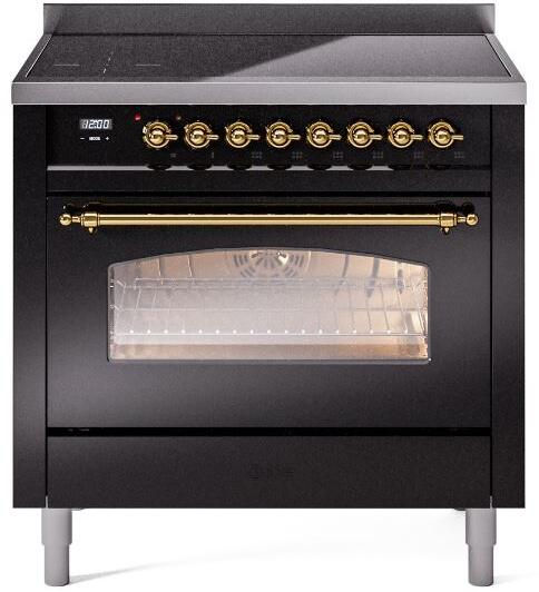 Freestanding induction range front view with brass control knobs and oven window