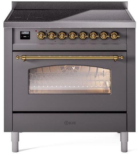 Matte graphite induction range with lit oven window, brass handle, and control knobs