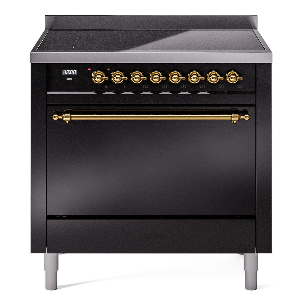 Black induction range with countertop controls and closed oven door with brass handles