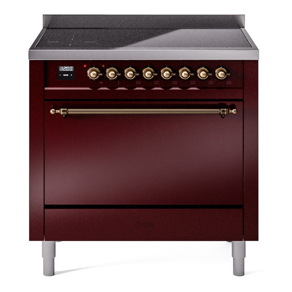 Induction range front with burgundy oven door and brass control knobs