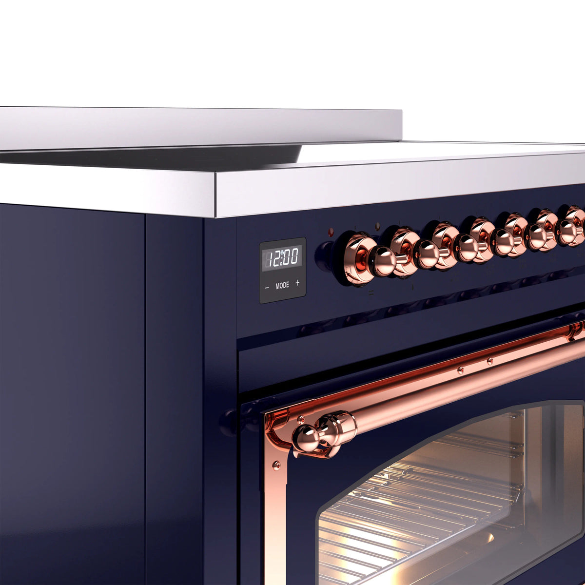 Induction range control panel with copper knobs and illuminated oven door