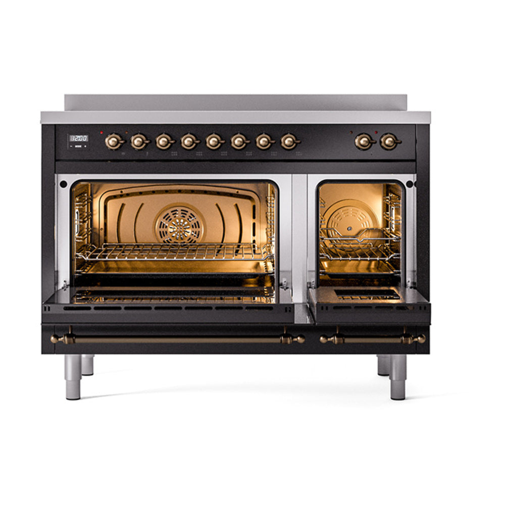 Open glossy black induction range ovens with interior racks and warm lighting