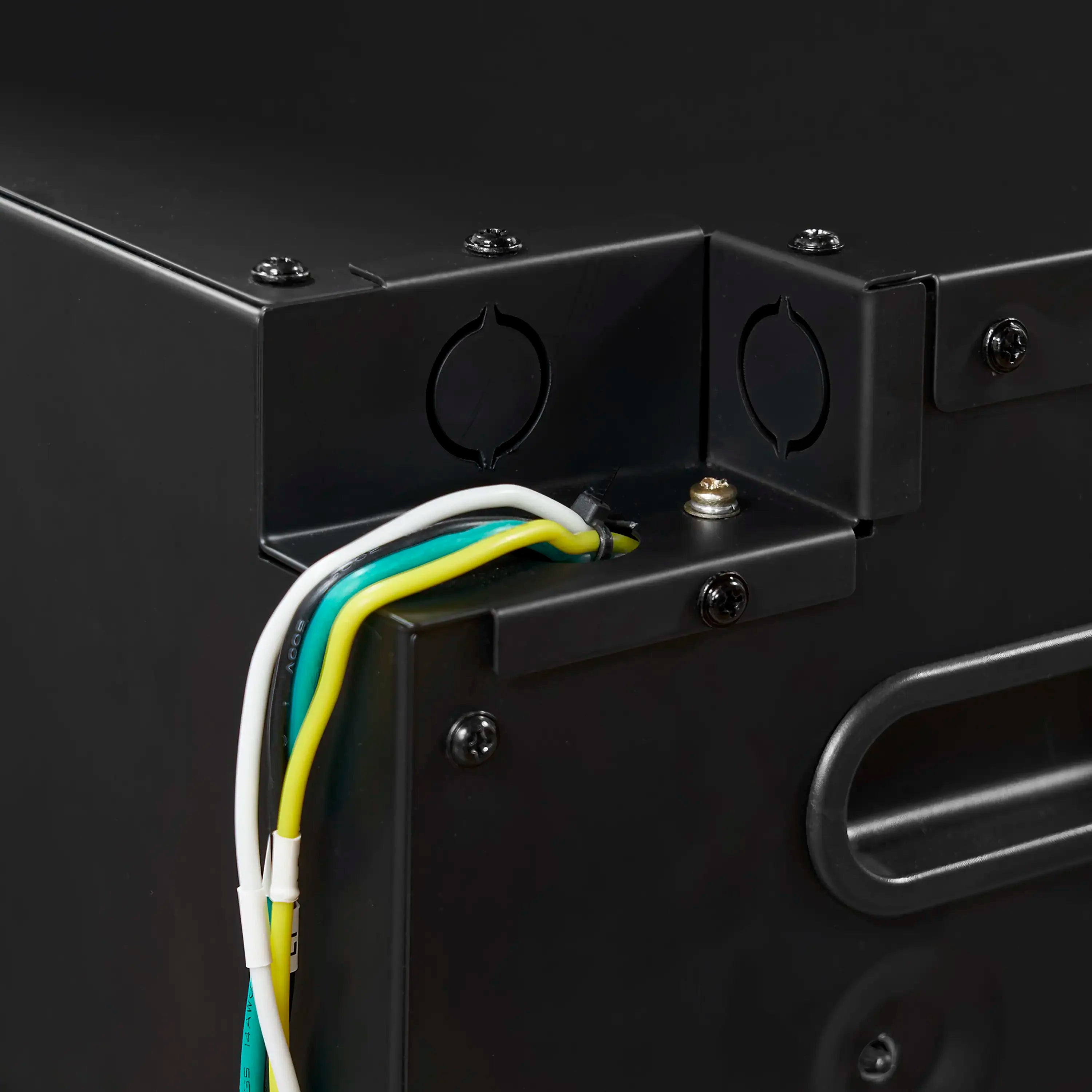 Wiring access port with color-coded cables on black electric fireplace interior