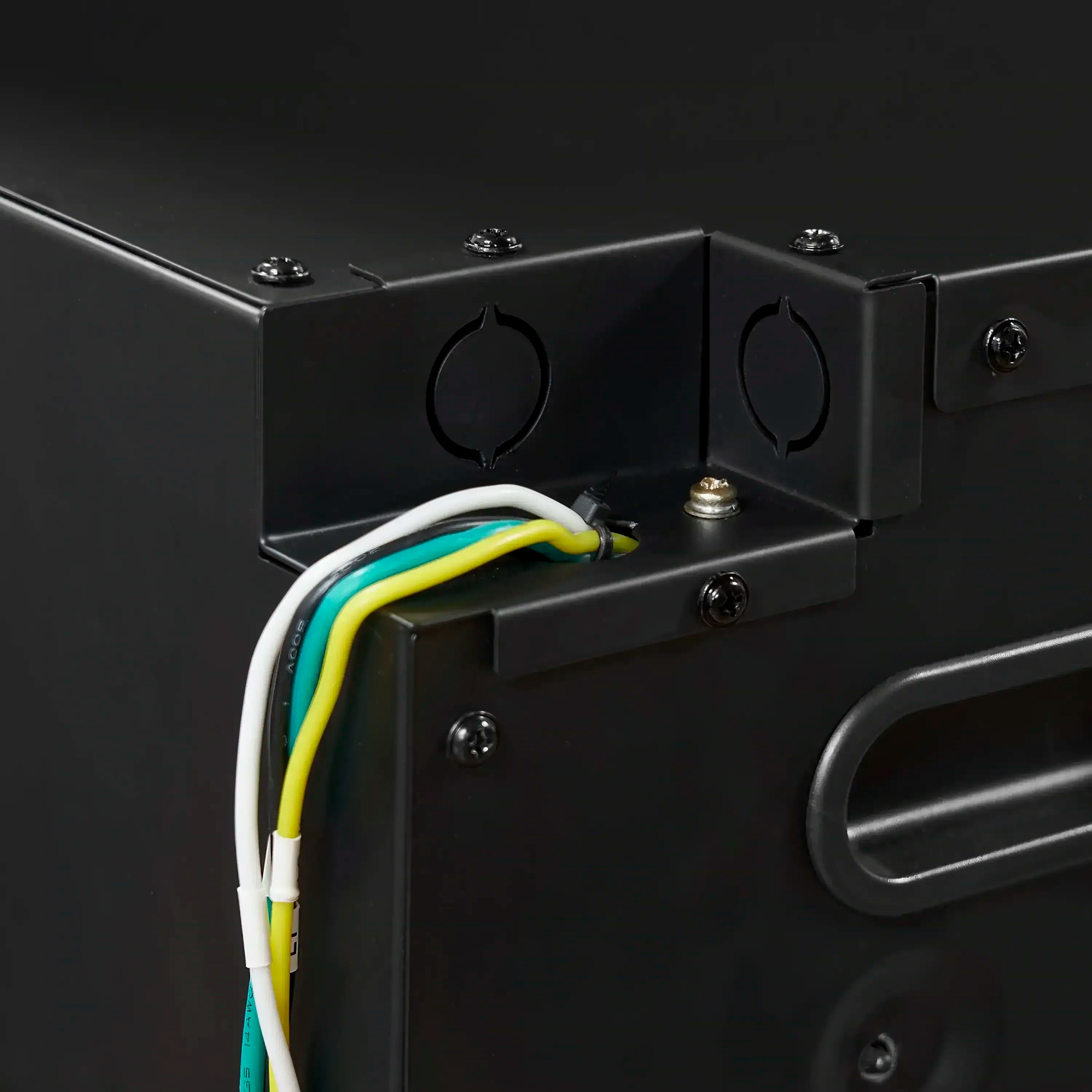 Electric fireplace control panel close-up with wiring connections on a dark housing