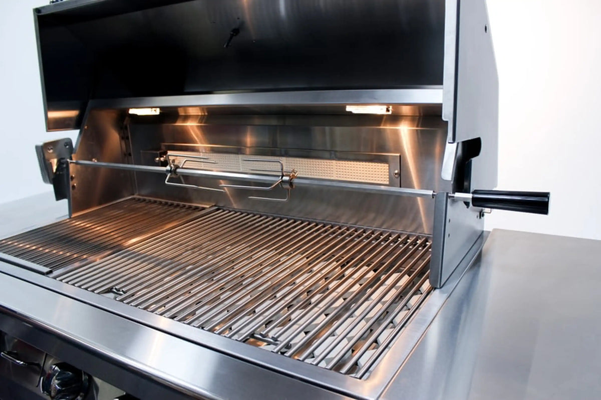 Open stainless grill hood revealing wire cooking grate and warming rack