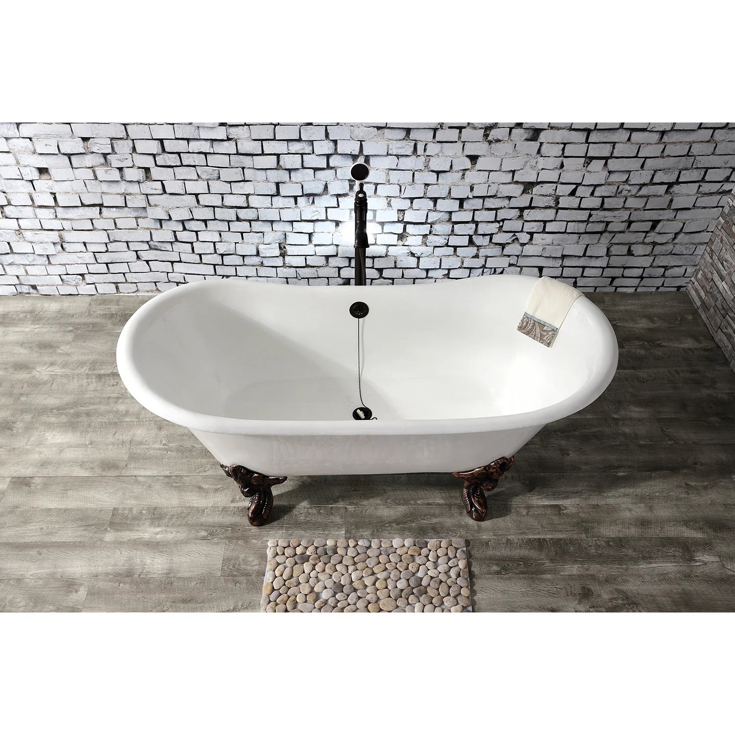 White oval clawfoot bathtub with dark bronze legs and built-in center drain/overflow