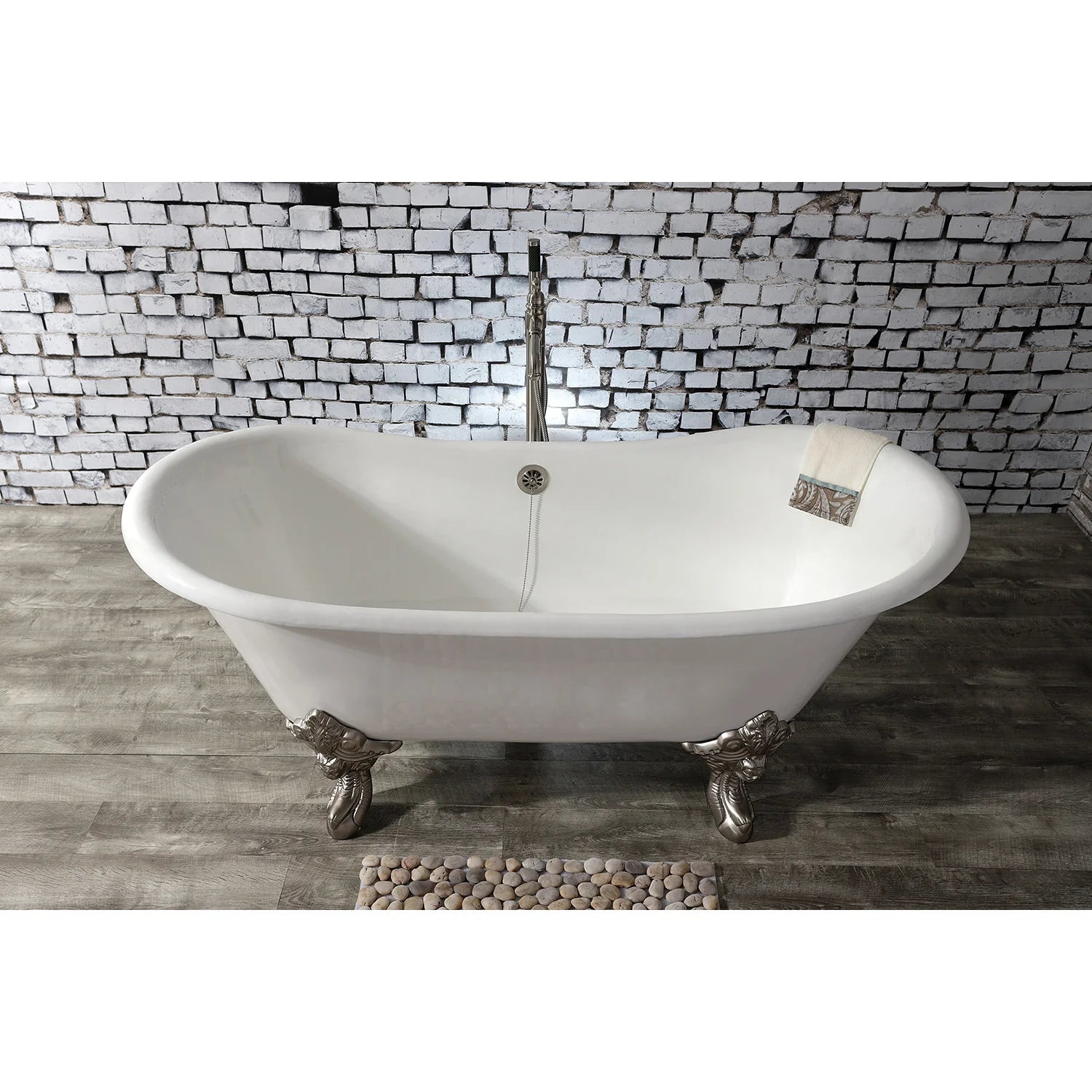 White oval double slipper bathtub on ornate claw feet with brushed nickel accents and center drain