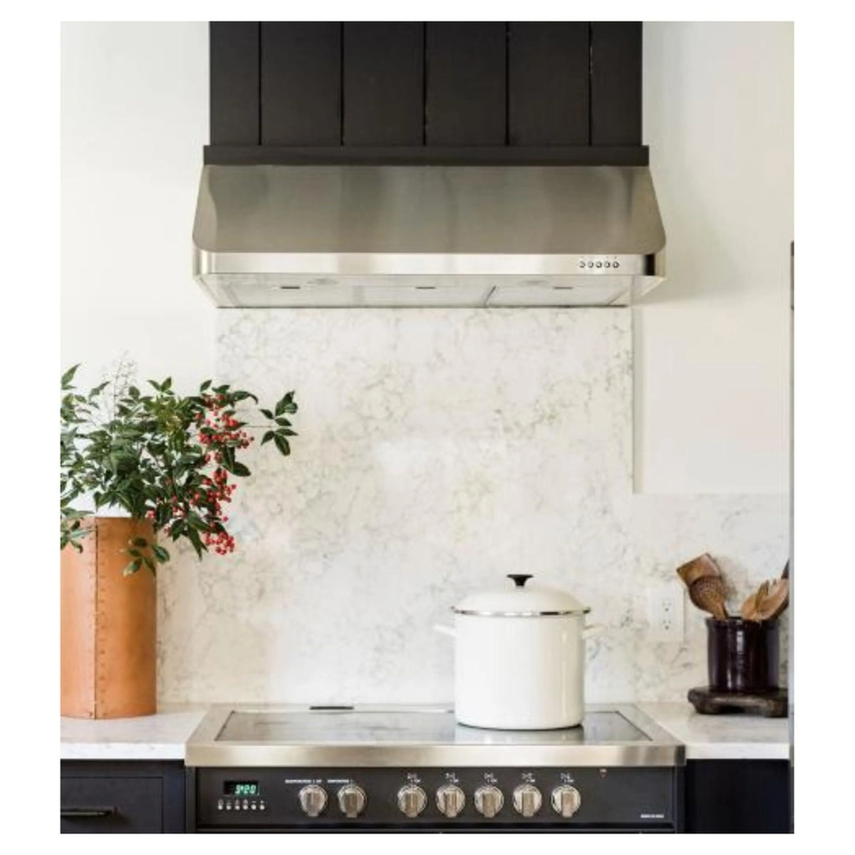 Stainless steel undermount range hood with chimney-style canopy over cooktop