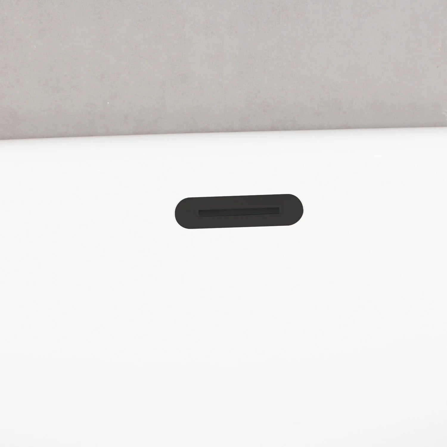 Matte black rectangular overflow slot on white acrylic tub