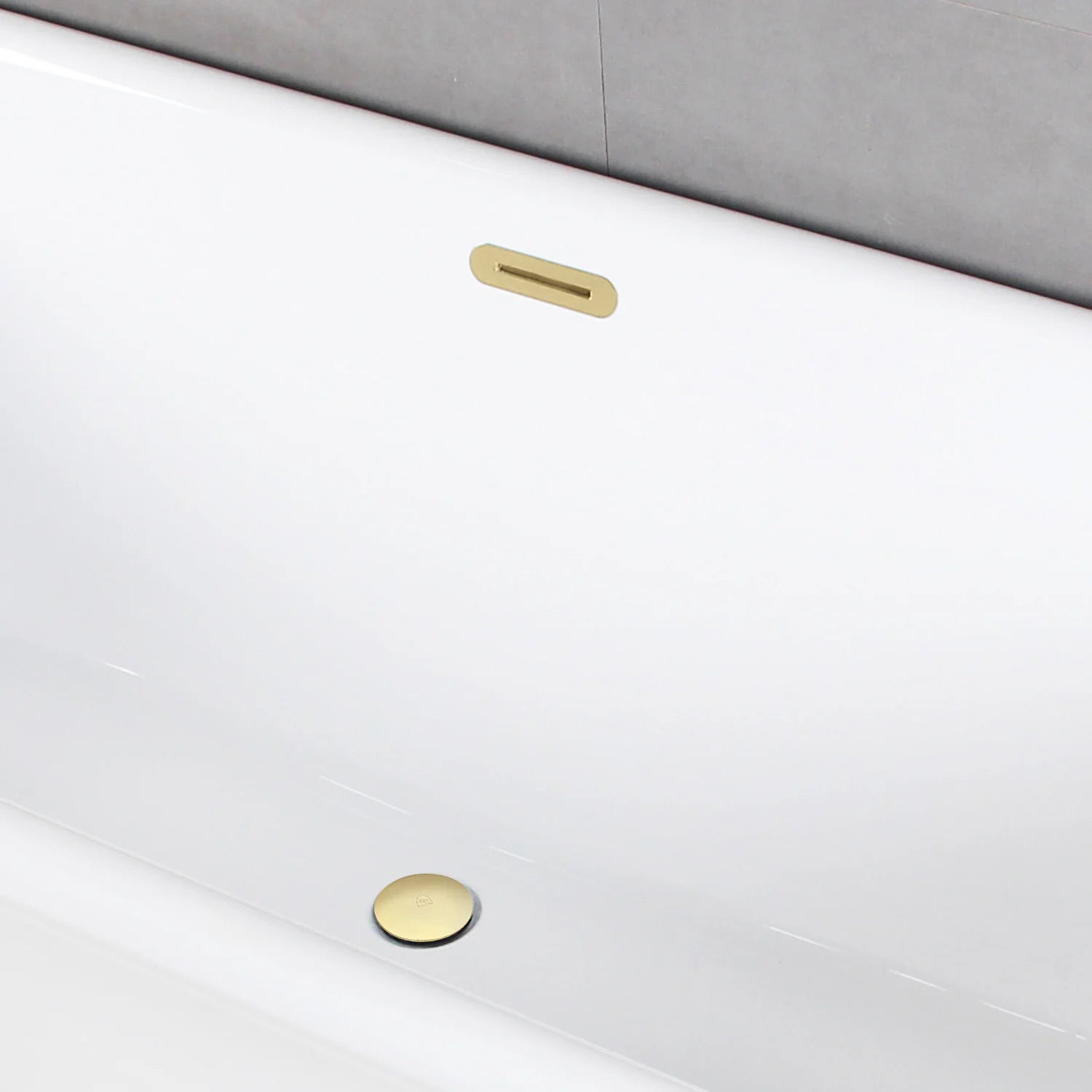 Glossy white tub with polished brass drain and rectangular overflow trim