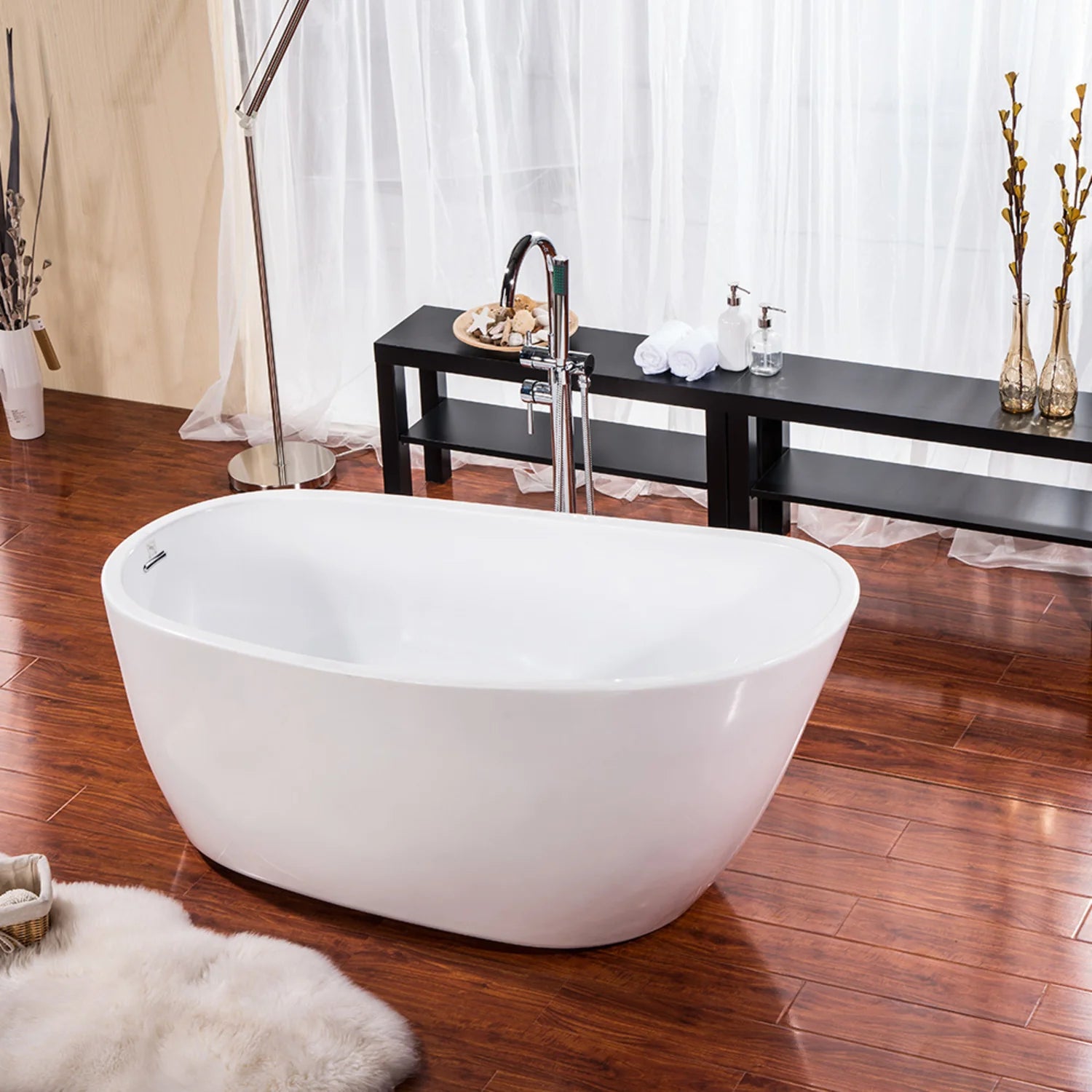 Glossy white oval freestanding acrylic bathtub on floor, front view