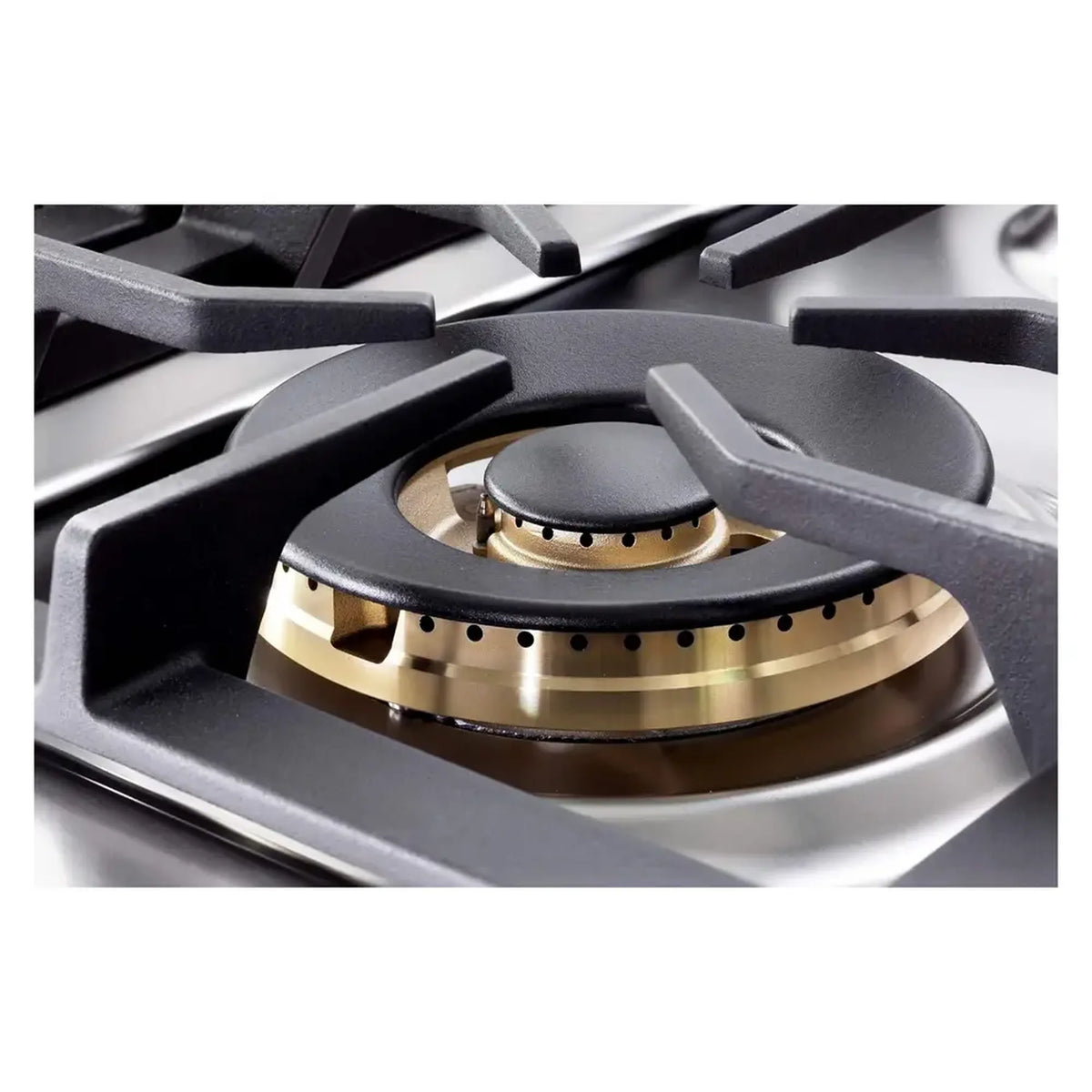 Close-up of a gas burner with black cap and brass burner ring