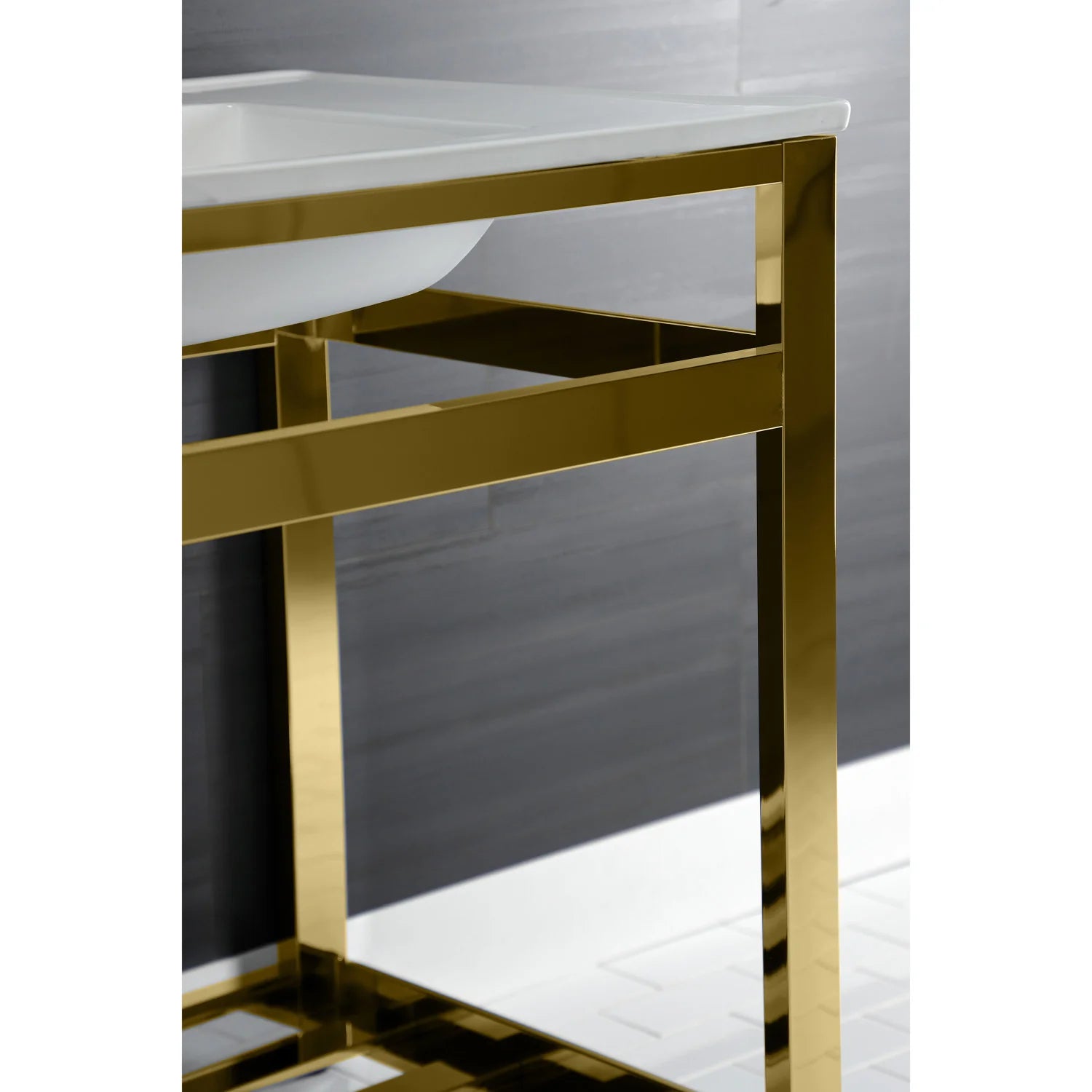 Polished brass console sink frame with open storage shelf under the white basin