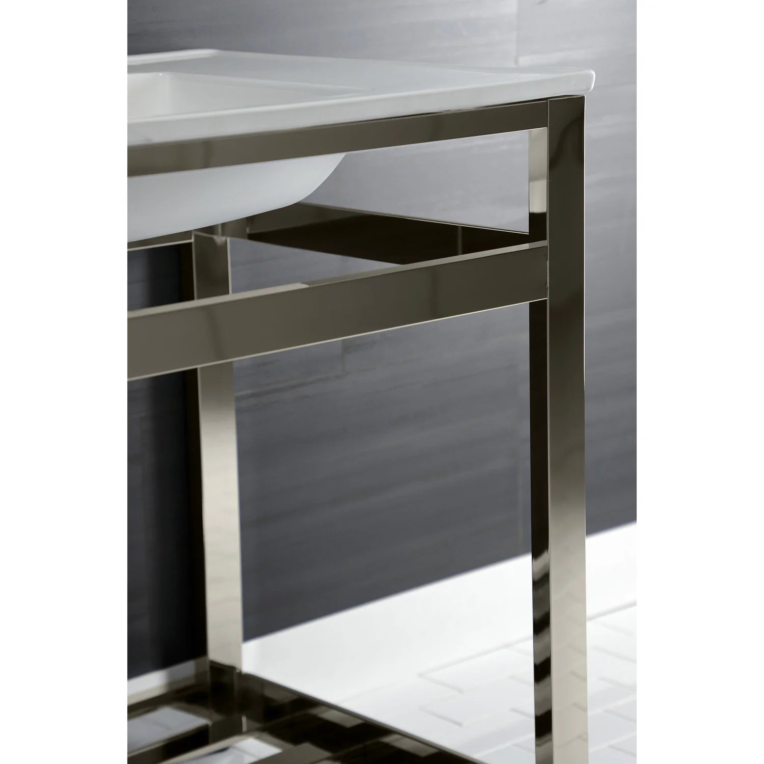 Side view of white ceramic sink on polished nickel steel console with open shelf