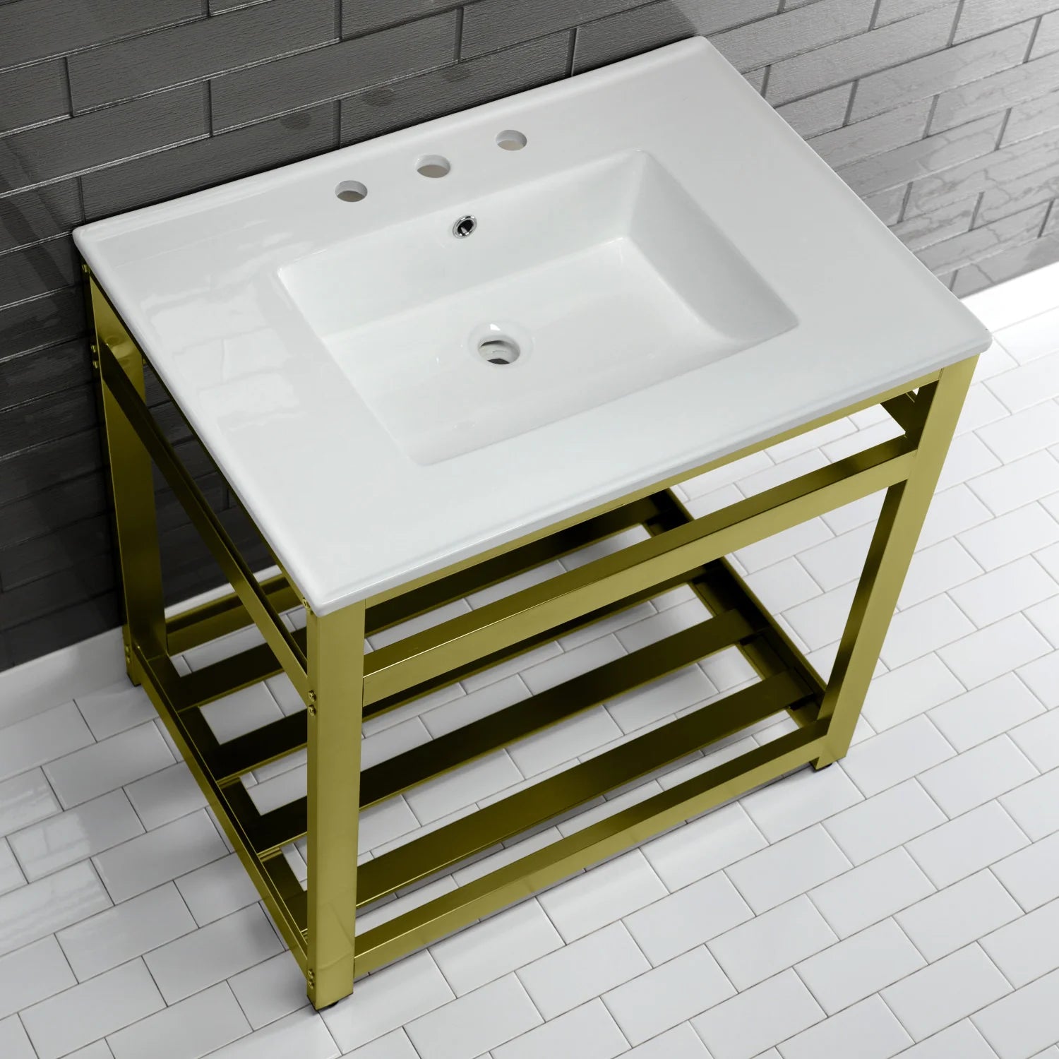 White ceramic three-hole console sink with brushed brass frame and open lower shelf