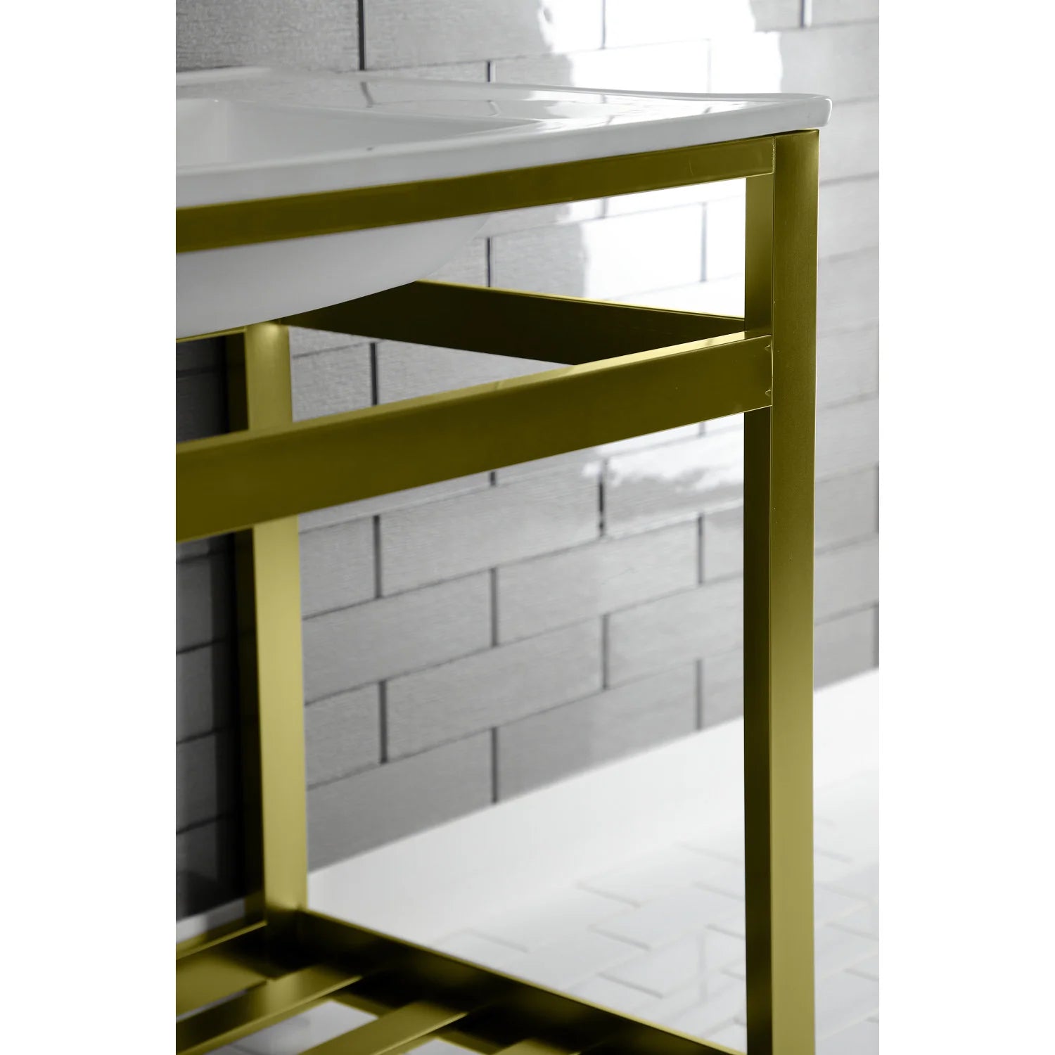 Brushed brass console sink frame with open middle shelf under white ceramic basin