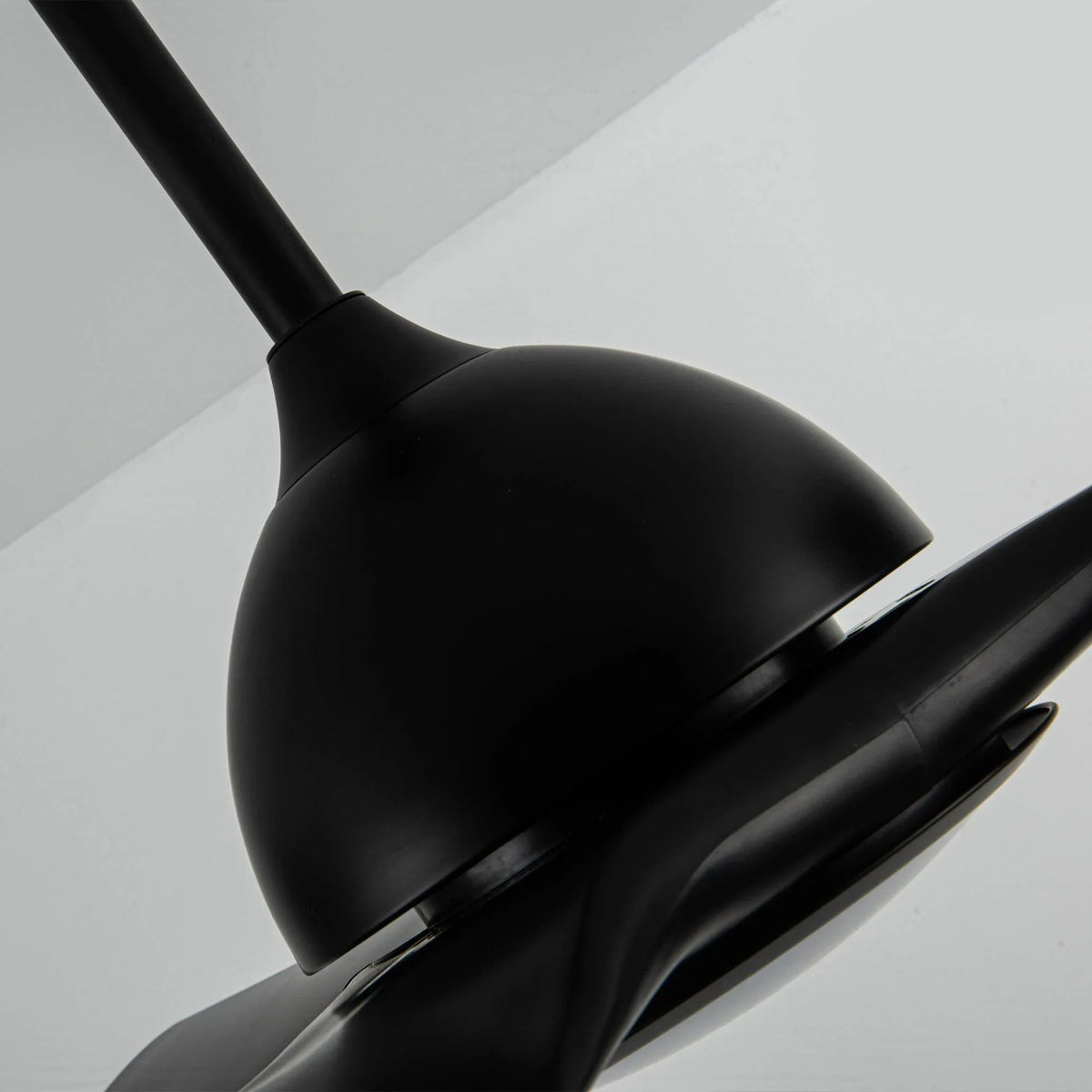 Black ceiling fan blade and motor housing detail with slim trim ring