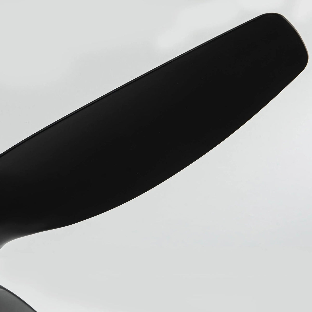 Close-up of black ceiling fan blade edge with smooth matte finish