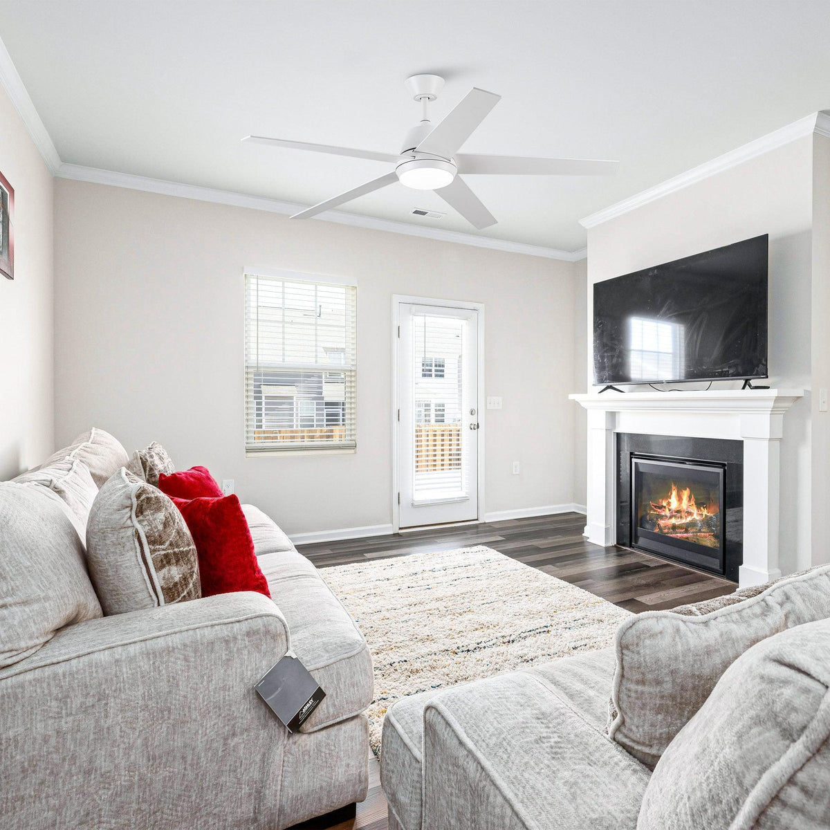 White ceiling fan with five blades and round LED light centered under the canopy
