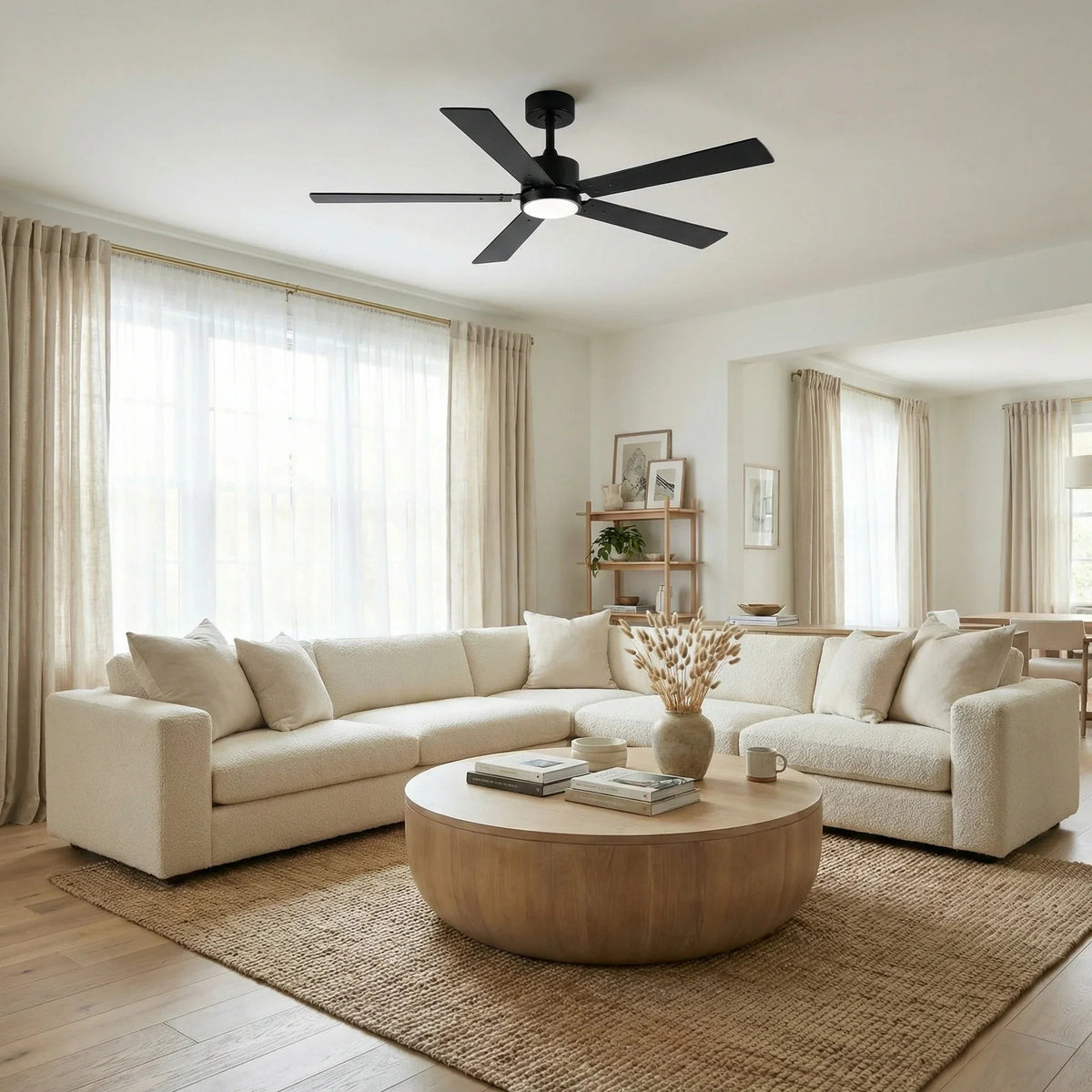 Black ceiling fan with circular LED light and 5 blades in a living room setting