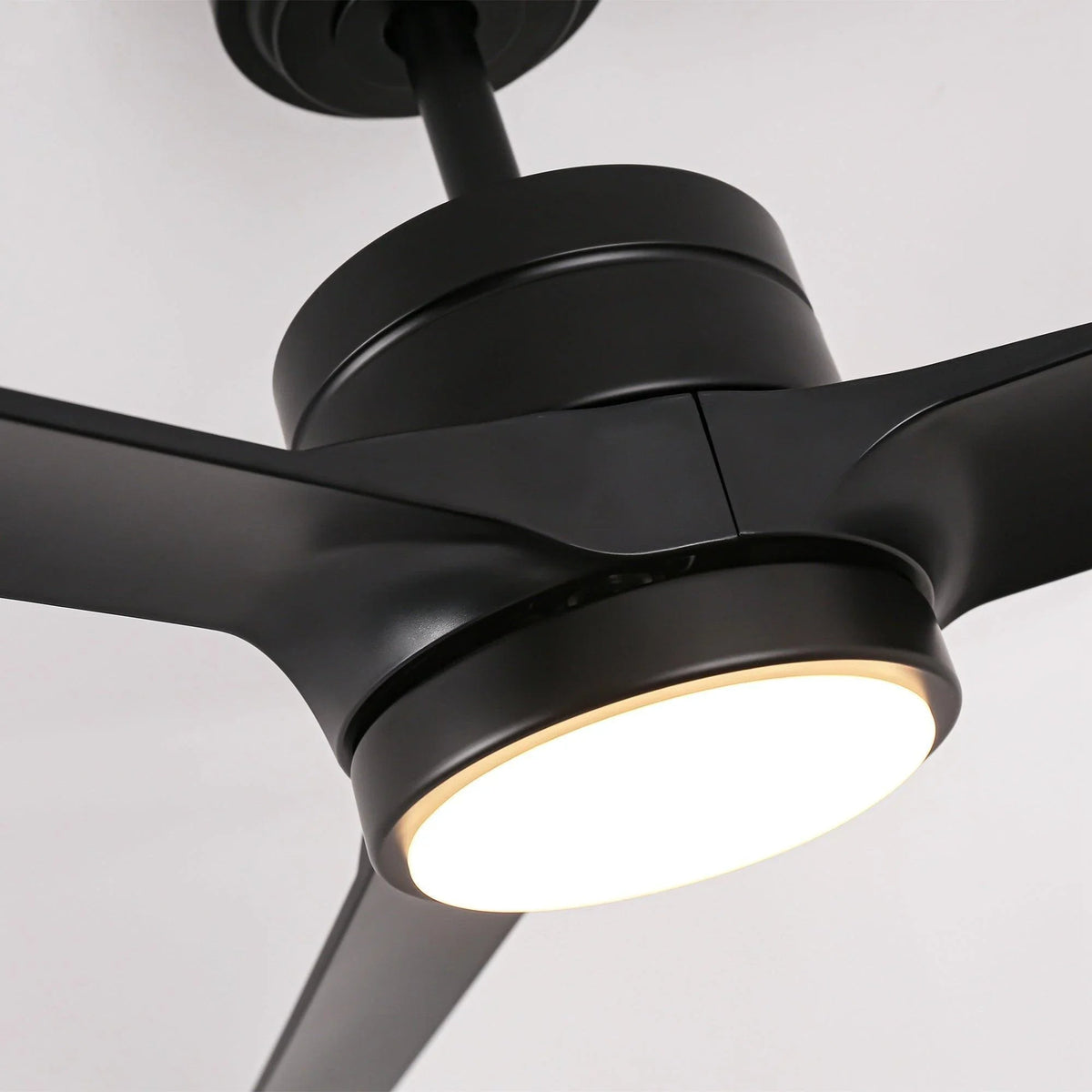 Black ceiling fan hub with blade arms and glowing LED light