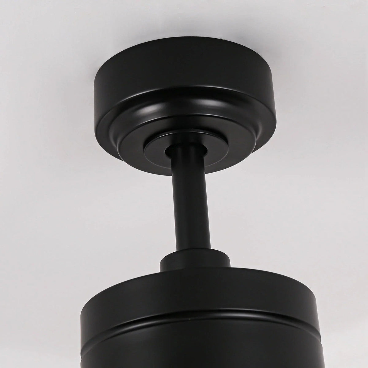 Black ceiling fan mounting canopy and downrod with motor housing