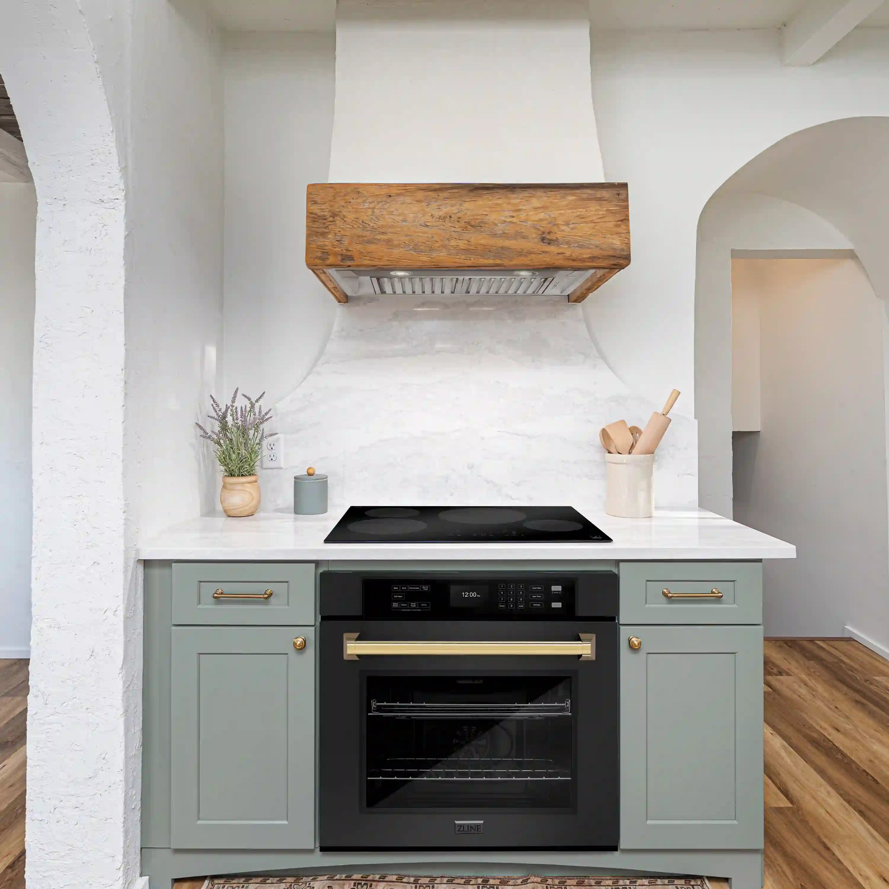 Built-in black stainless single wall oven with polished gold handle, door closed