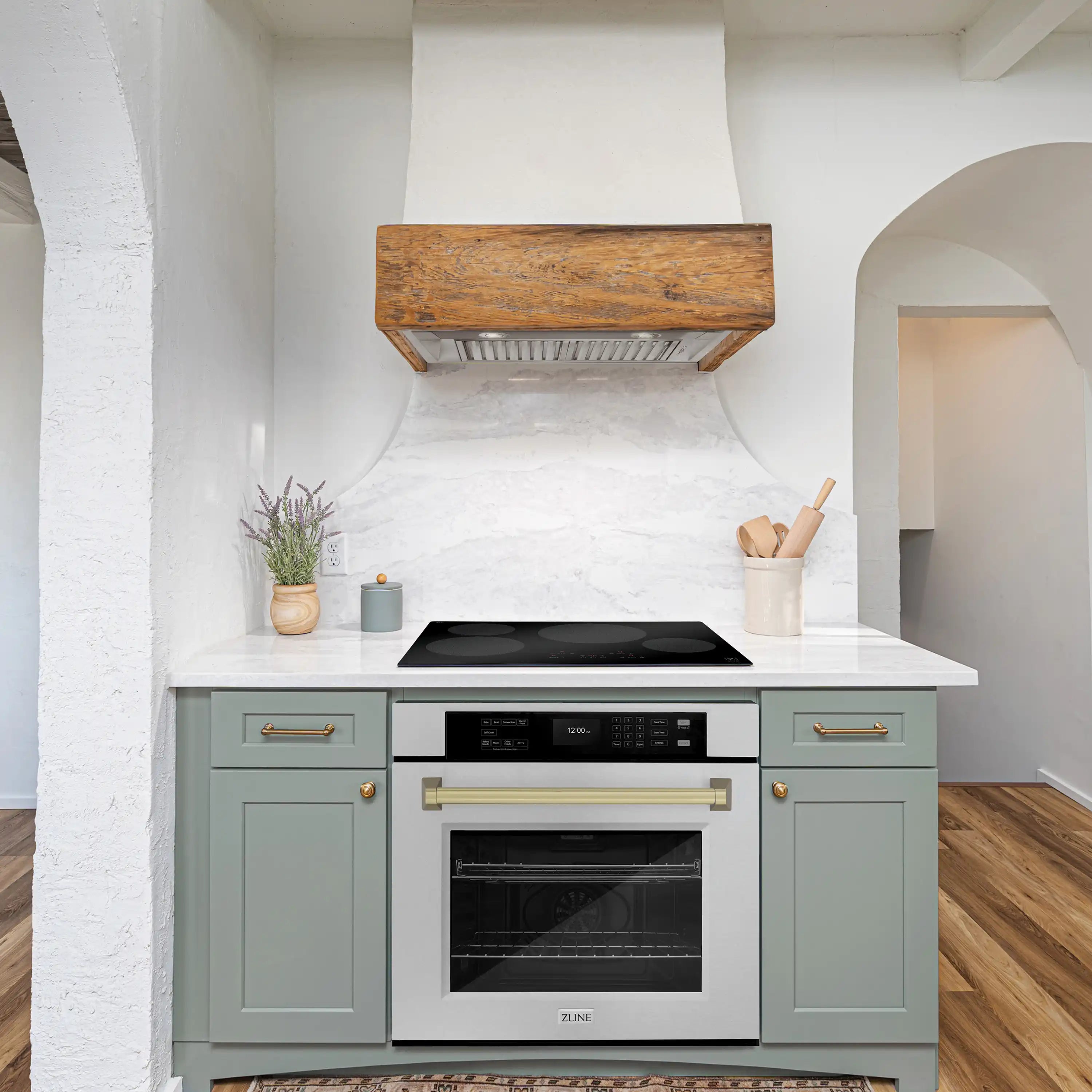 Built-in single wall oven in light cabinetry with satin stainless door and bronze handle