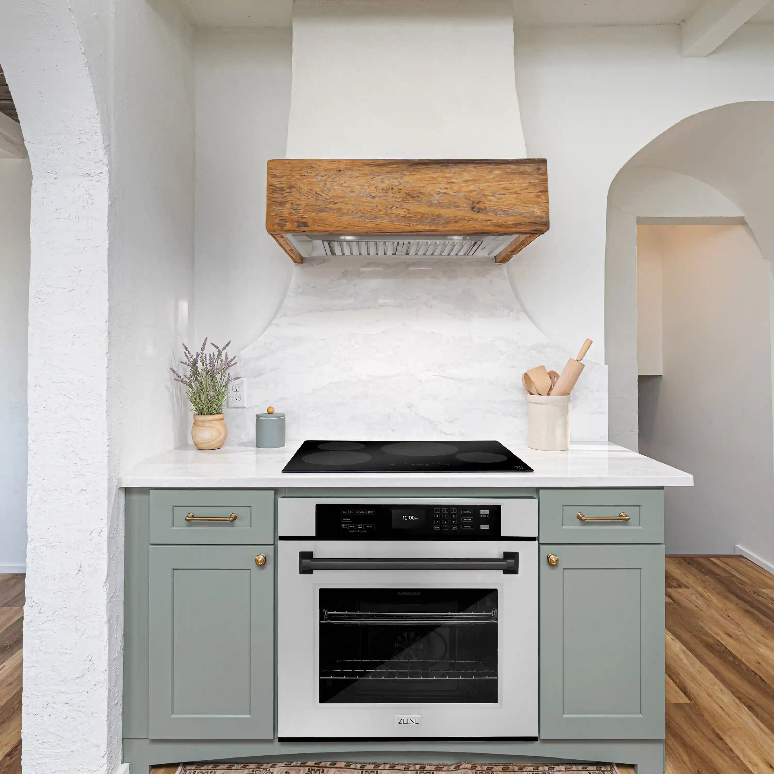 Built-in oven with black glass door and matte black handle under a countertop