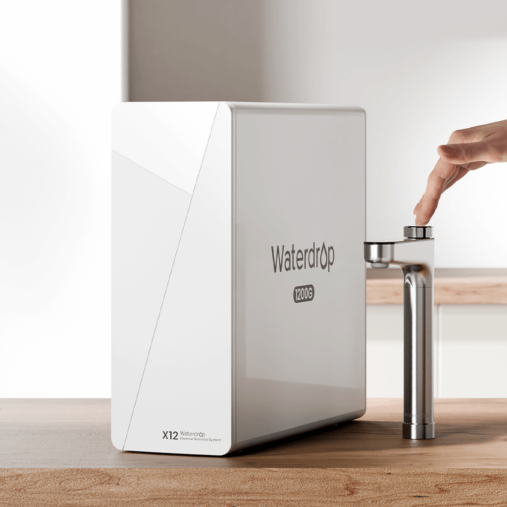 White tankless reverse osmosis filter unit with silver faucet on countertop