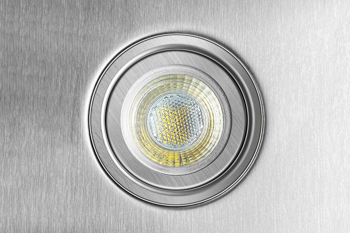 Circular LED light module on stainless steel range hood panel