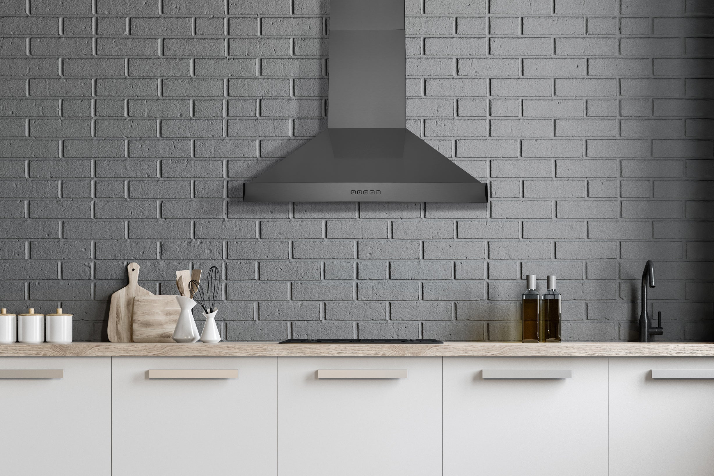Black stainless steel wall mount range hood with chimney, installed above the cooktop area