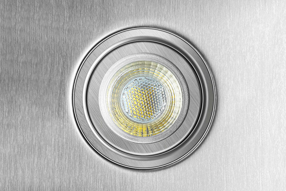Round LED light lens with reflective trim mounted on the stainless steel hood.
