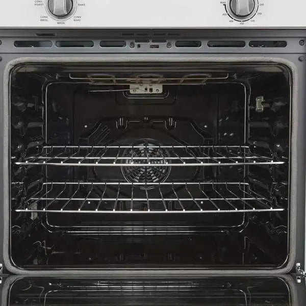 Open wall oven interior with two racks, metal heating elements, and tray supports