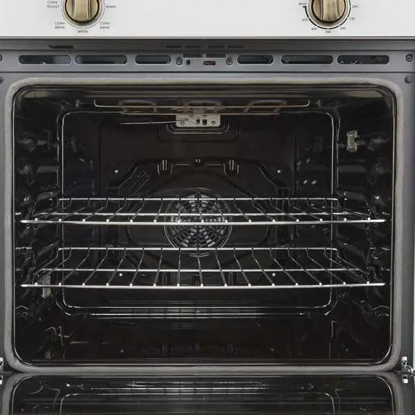 Wall oven interior with dark glass door, rack rails, and bake rack