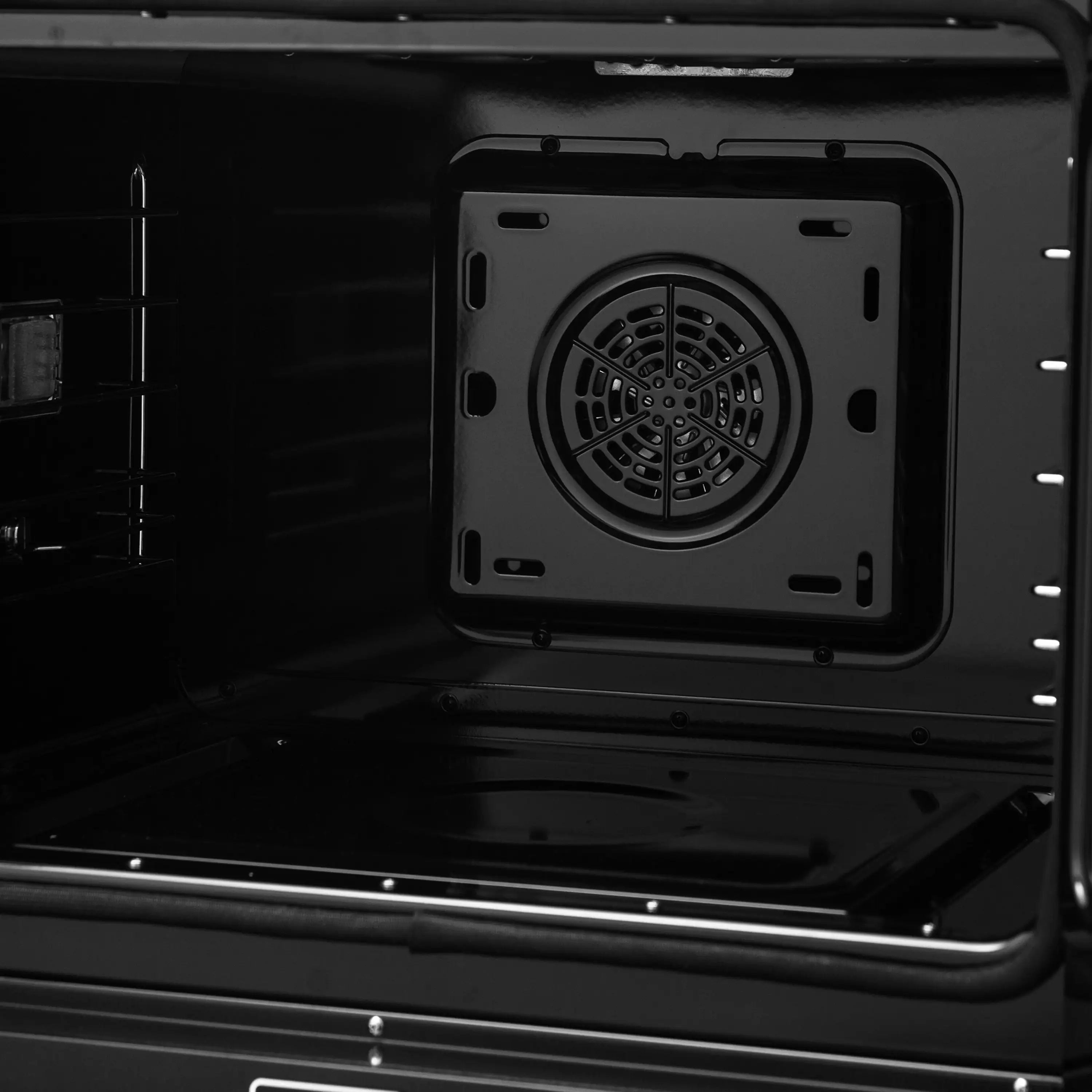 Black oven interior back panel with square fan and circular vent cover.