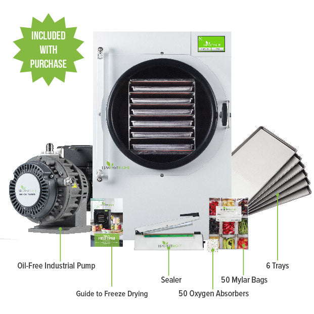 White home freeze dryer with circular chamber, vacuum pump, trays, and mylar bags
