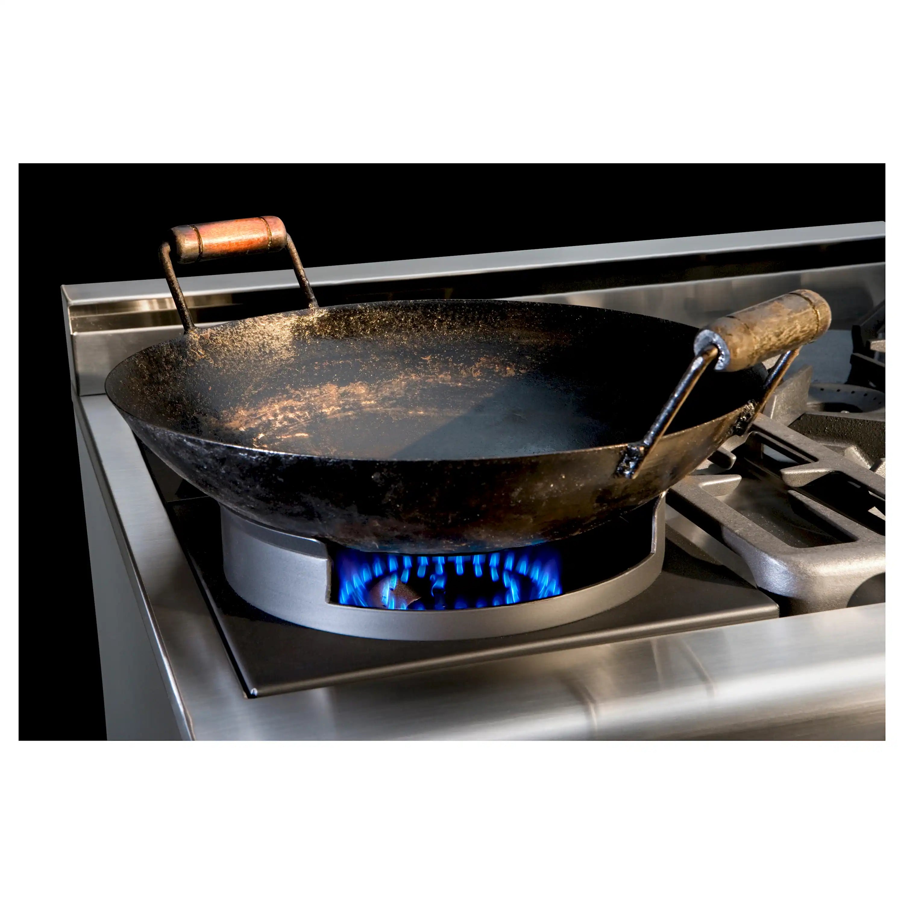 Wok ring over gas burner with blue flame, stainless steel cooktop
