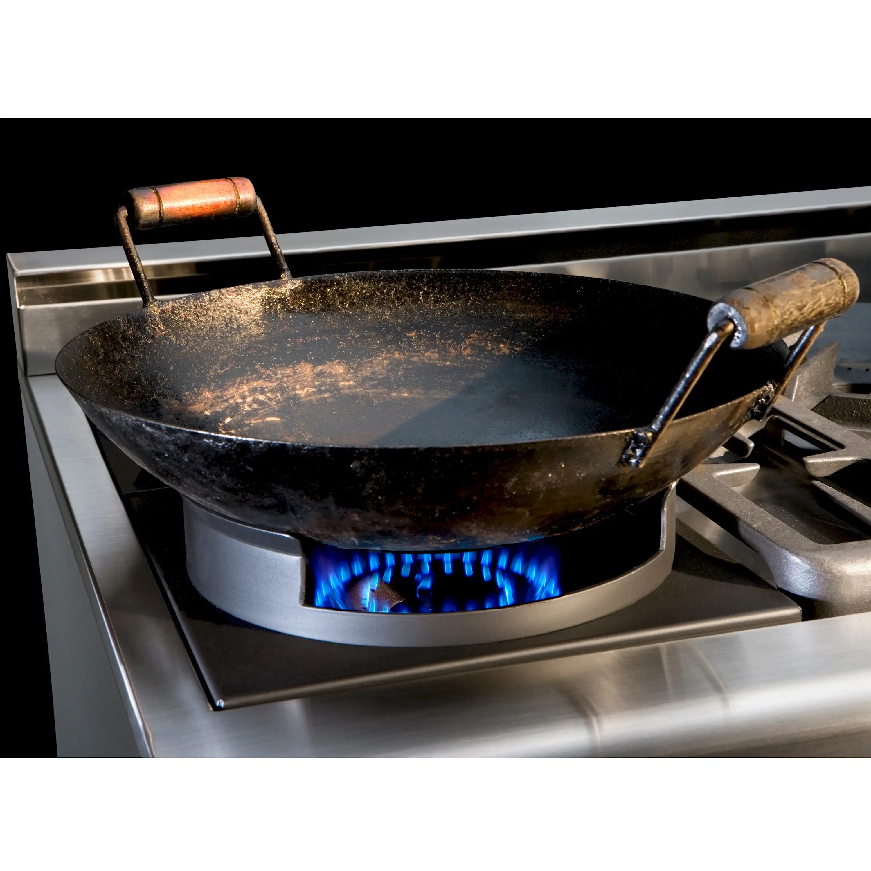 Wok-style burner with blue flame and cast pan supports on stainless steel range
