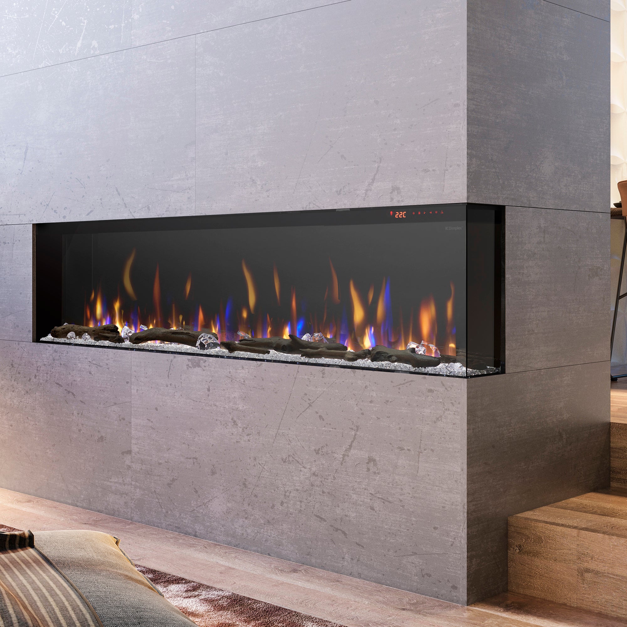 Built-in linear electric fireplace with orange flames and dark rock bed