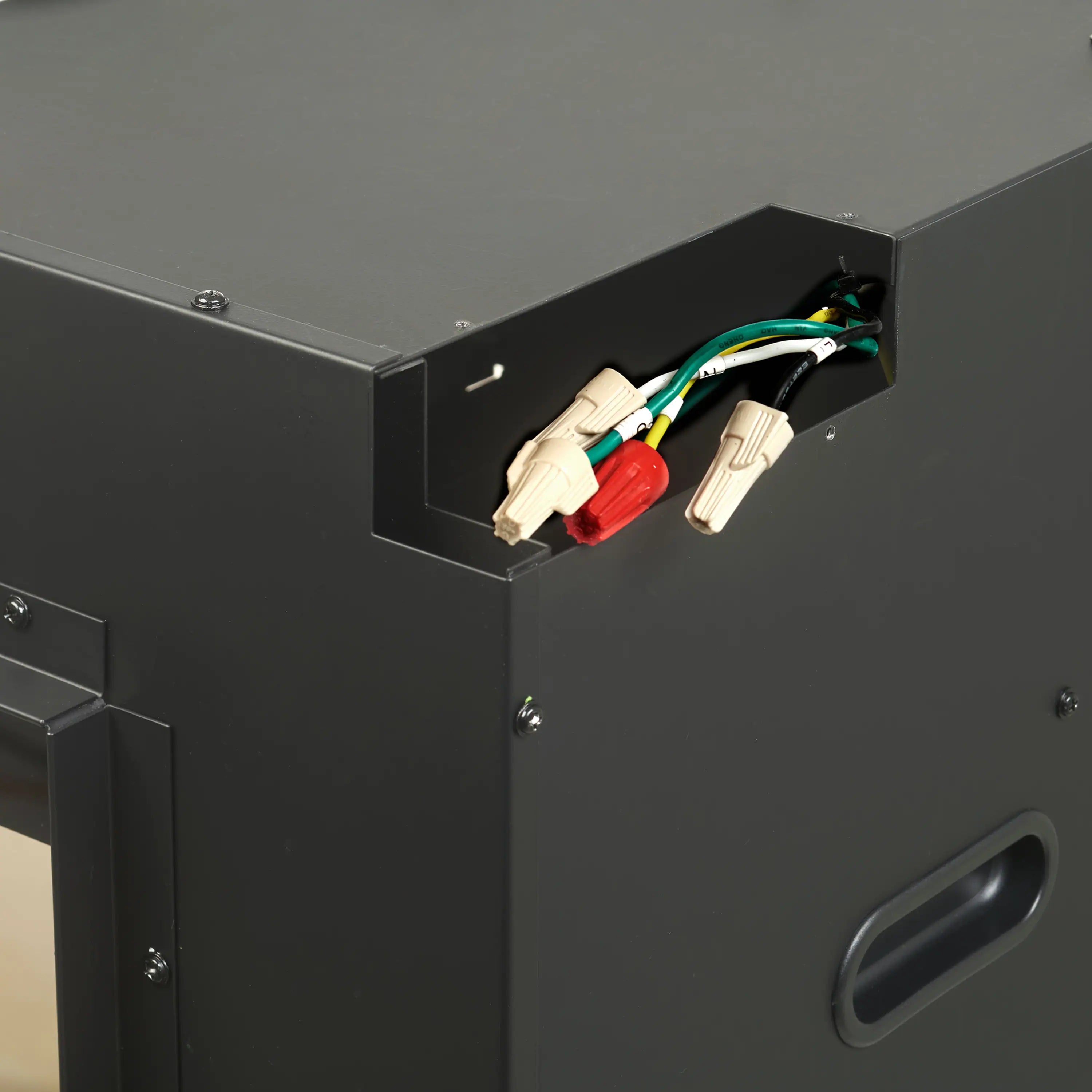 Fireplace housing with exposed wire connectors inside a black metal panel