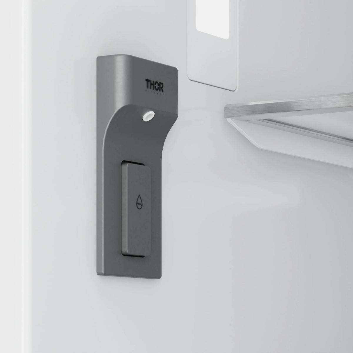 THOR stainless refrigerator/freezer handle area with dispenser lever and logo