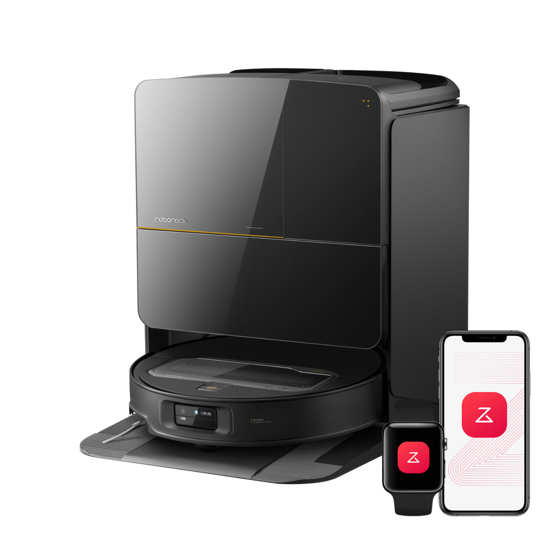 Black robot vacuum on charging dock with mechanical arm retracted and smartphone display
