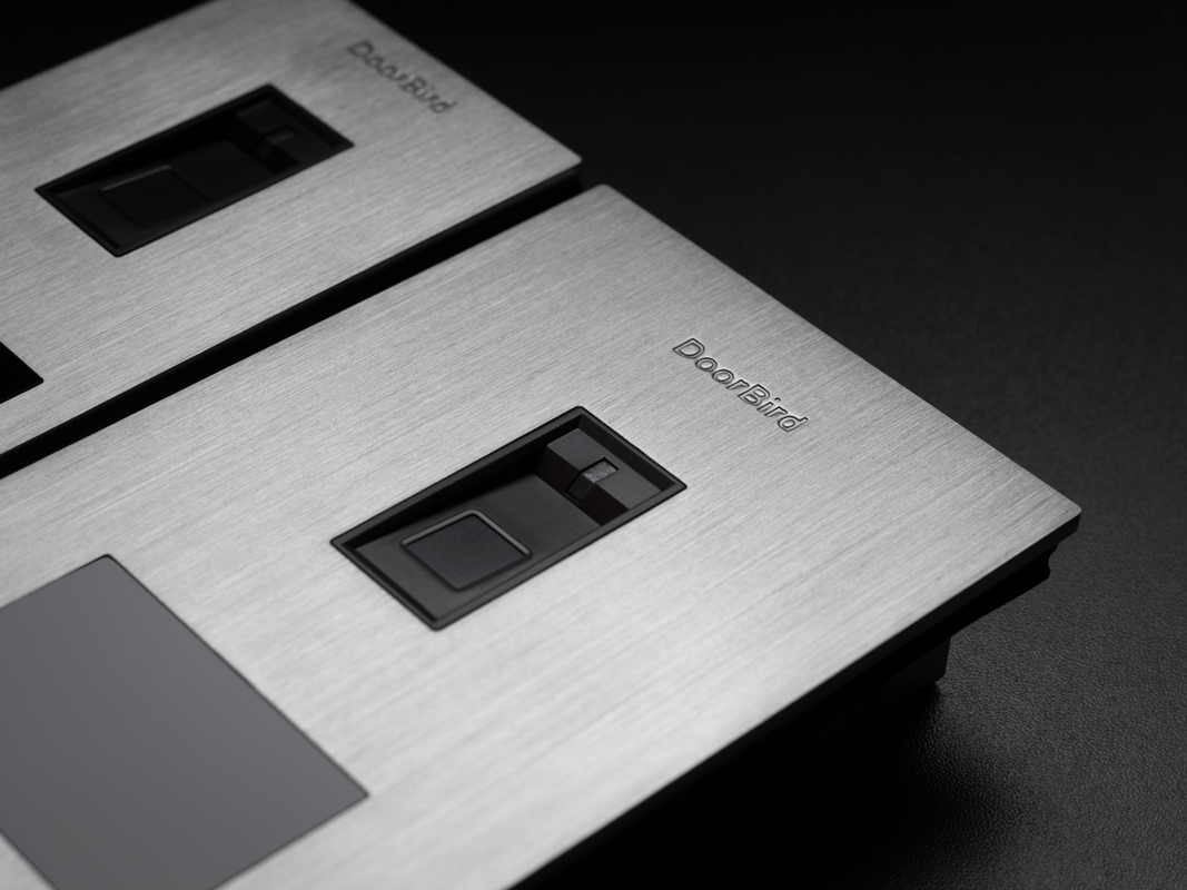 DoorBird brushed stainless flush-mount access panel with fingerprint sensor window and buttons