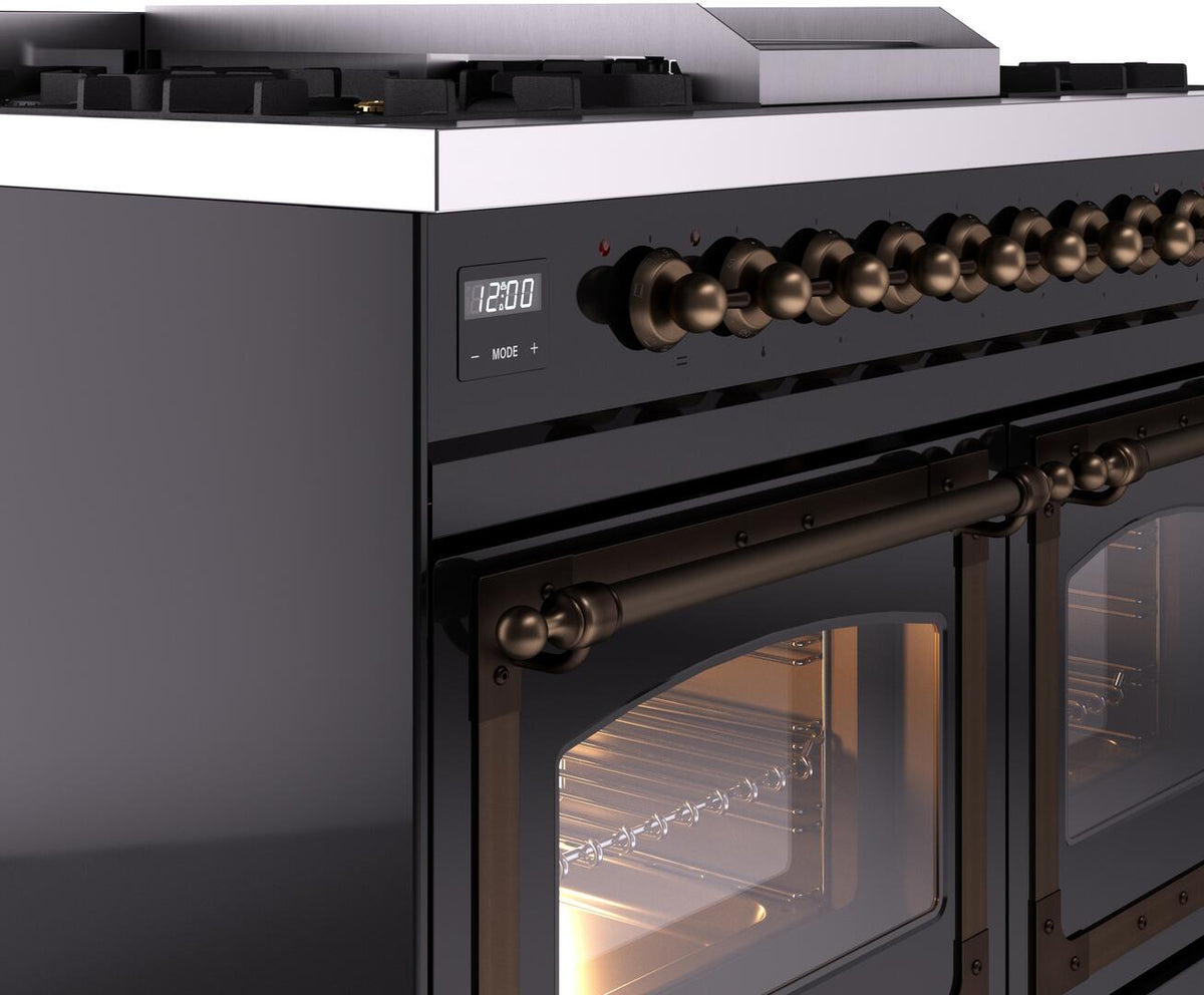 Glossy black range control panel with bronze-style knobs and illuminated oven window