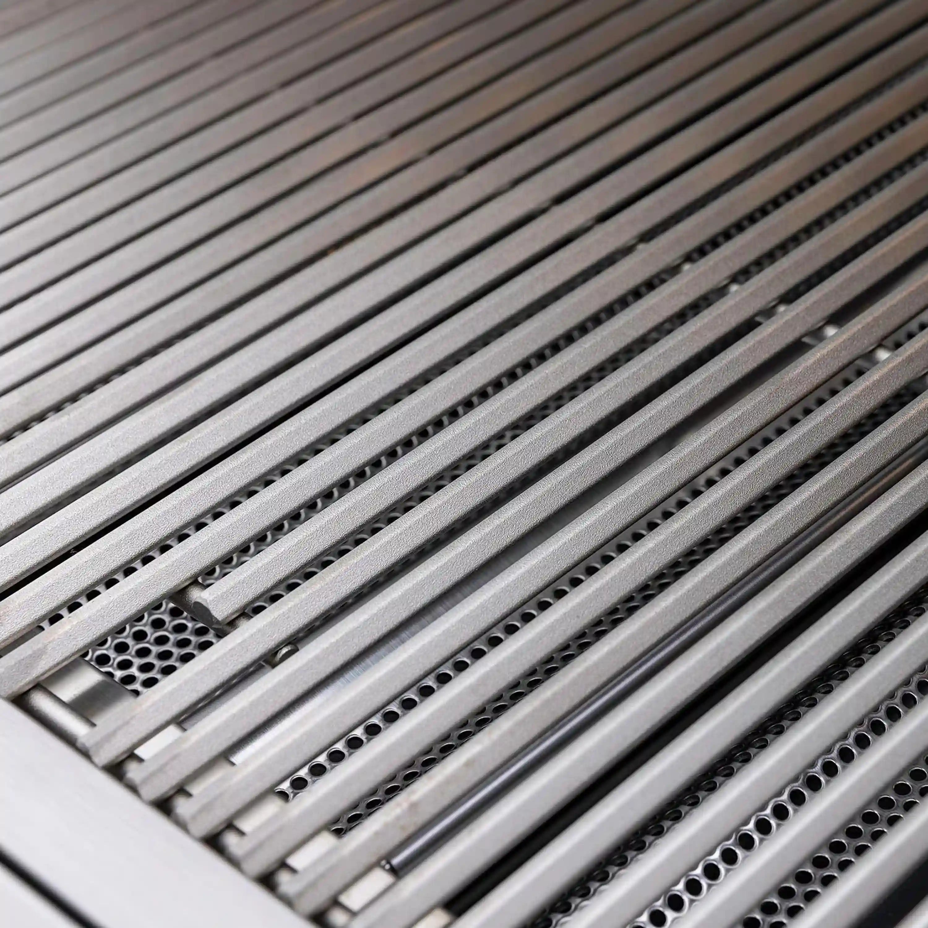 Close-up of stainless cooking grates with perforated heat-distribution surface
