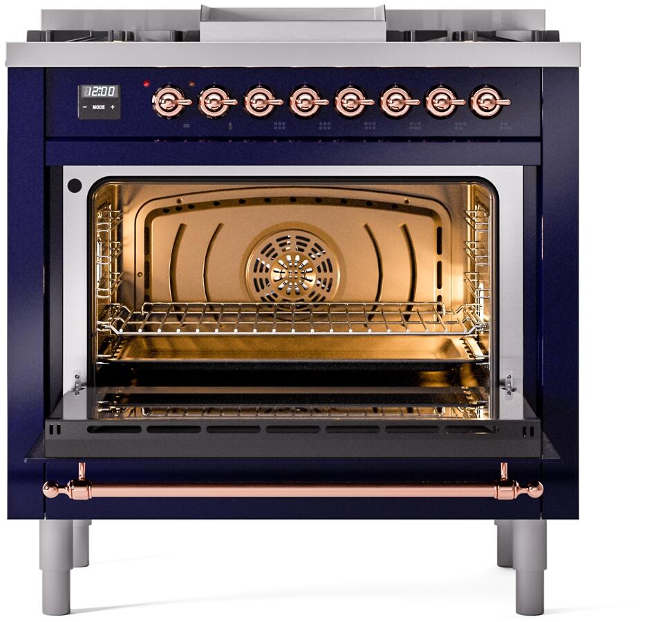 Open oven with copper accents, wire racks, and fan at back inside a dual fuel range