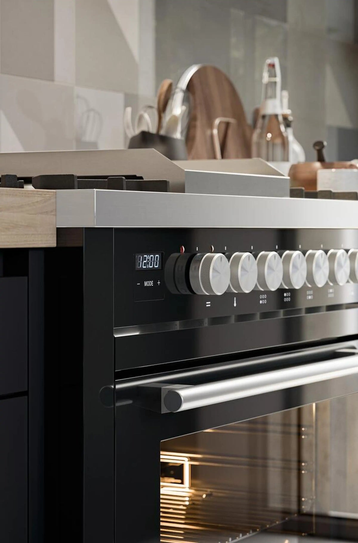 Glossy black range with front control panel, stainless handle, and illuminated oven interior